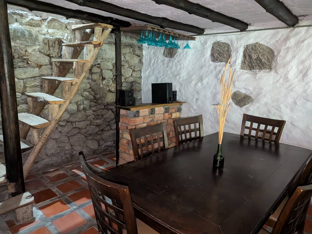 Stone dining room and rustic stair