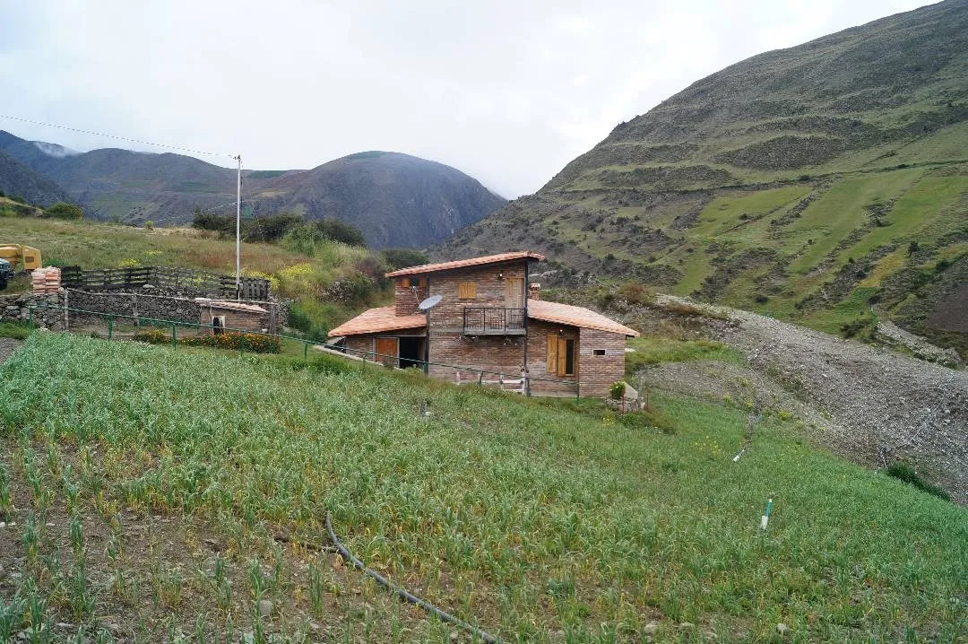 The Terra finca in Gavidia, with planted fields and the páramo mountains behind
